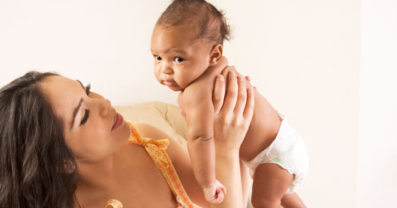 a woman is holding up a baby depicts the product in a real-world setting, enhancing visual appeal.