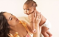 a woman is holding up a baby depicts the product in a real-world setting, enhancing visual appeal.