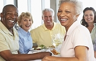 a man and woman sitting at a table with food. highlights the environmental friendliness and user-friendly packaging.