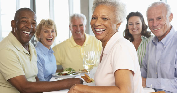 a man and woman sitting at a table with food. highlights the environmental friendliness and user-friendly packaging.